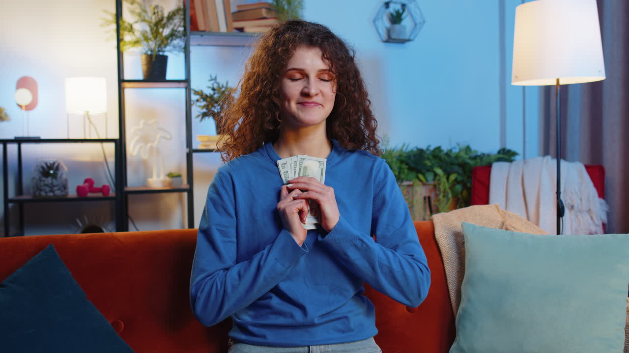 Successful rich happy woman counting dollar banknotes calculating budget savings savings at home