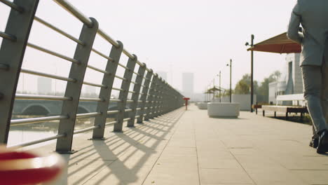 businessman walking on embankment in city