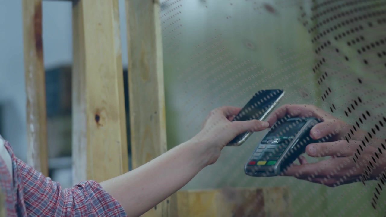 Animation of globe over hands of caucasian people using payment terminal
