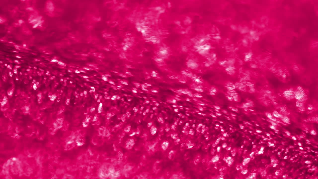 partículas brillantes rojas brillantes bajo un microscopio. movimiento browniano. las partículas fluyen suavemente. aditivo de combustible