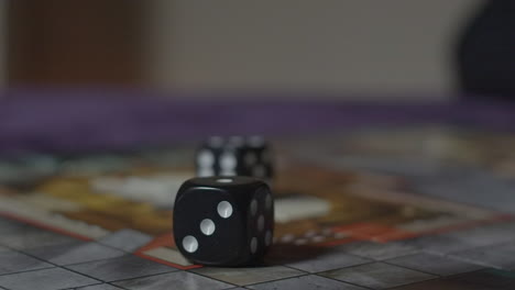 hand grabs rolled dice in slow motion