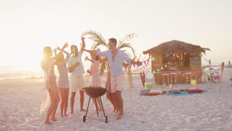 friends enjoying a bbq on the beach