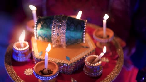 an elegant photograph captures a beautifully adorned candle tray featuring a small green drum at its center