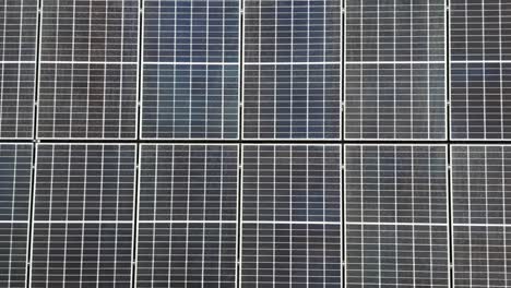 solar panel units on top of roof producing green energy during sunny summer day in usa. aerial top down flyover close up. electricity, sustainable, renewable energy in modern american neighborhood.