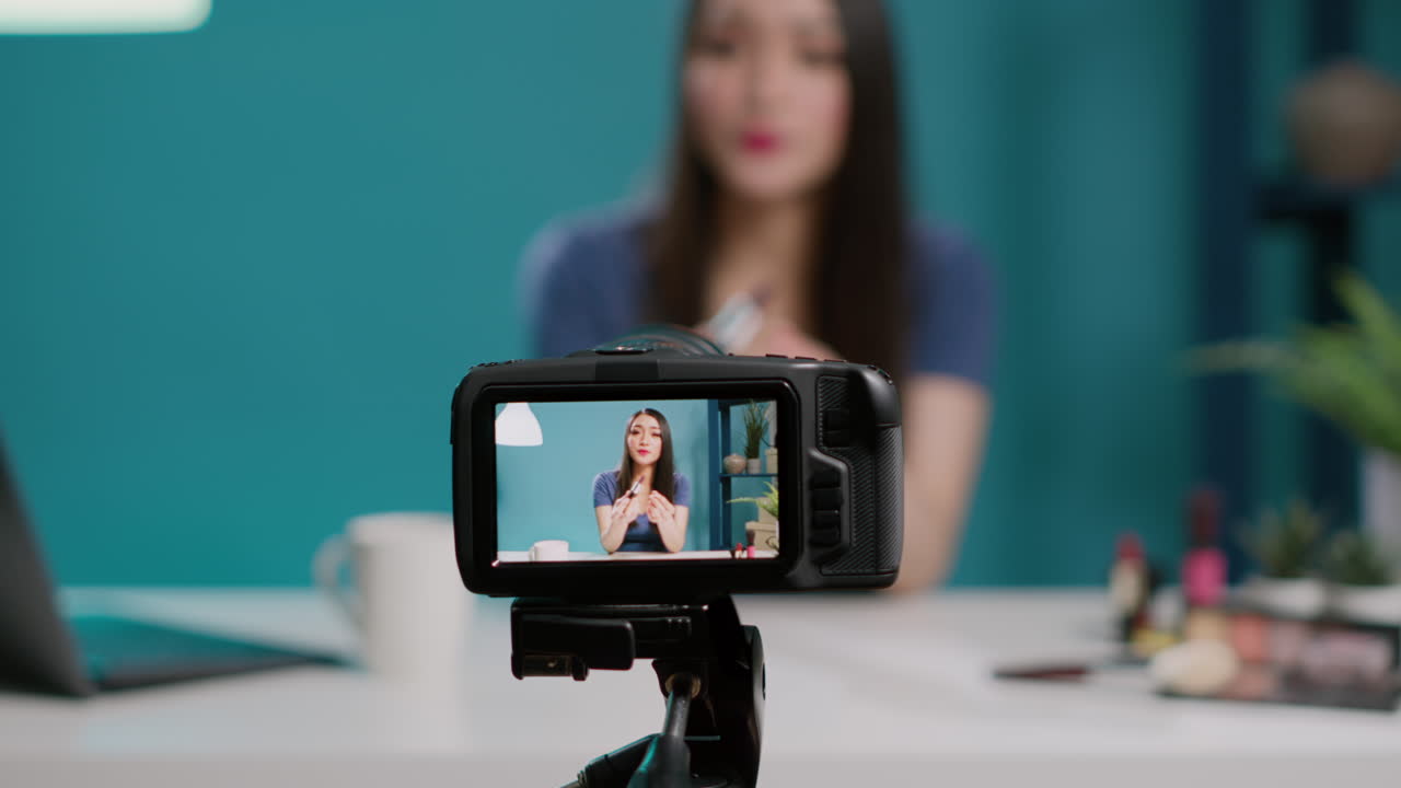 Female blogger recording beauty videoblog on camera