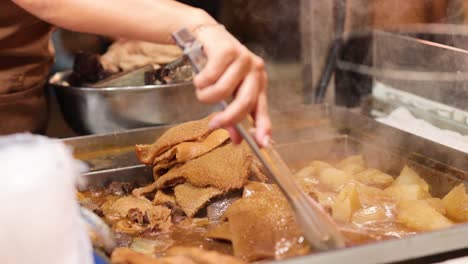 hands preparing food at a hong kong stall