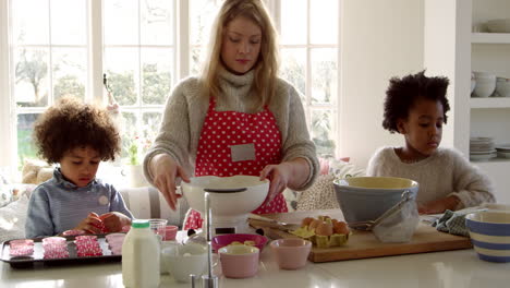 mother and children baking cake at home shot on r3d