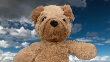 brown stuffed dog toy against a cloudy blue sky