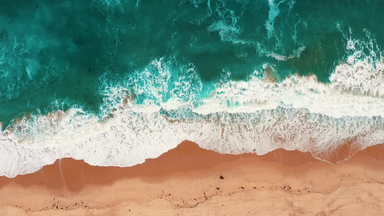 Foamy Waves On Sandy Shore Of Manhattan Beach In Los Angles, California