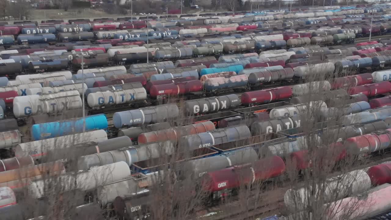 Train cars parked in a yard during the afternoon hours in autumn