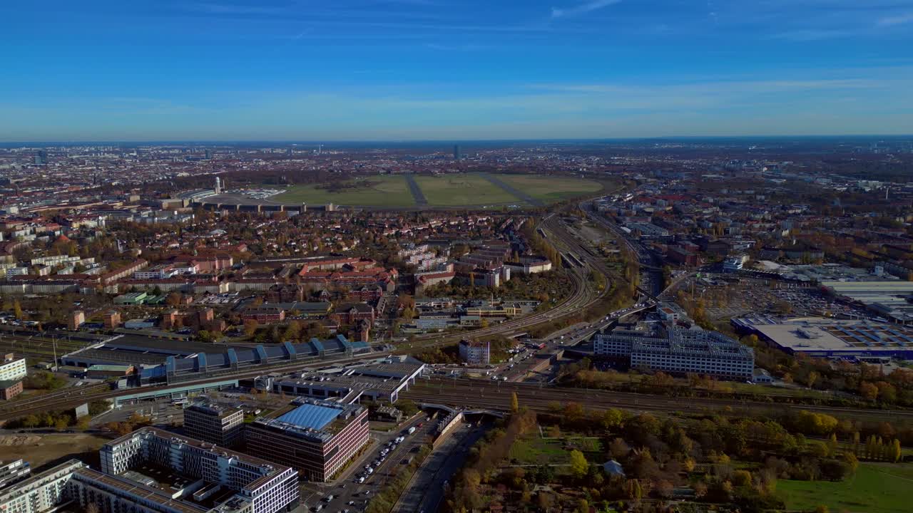 Aerial view tracking over the vast urban landscape of Berlin under a clear sky. Smooth aerial view flight panorama overview drone