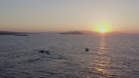 Aerial---Fishing-boat-in-Chania-Greece-at-sunset