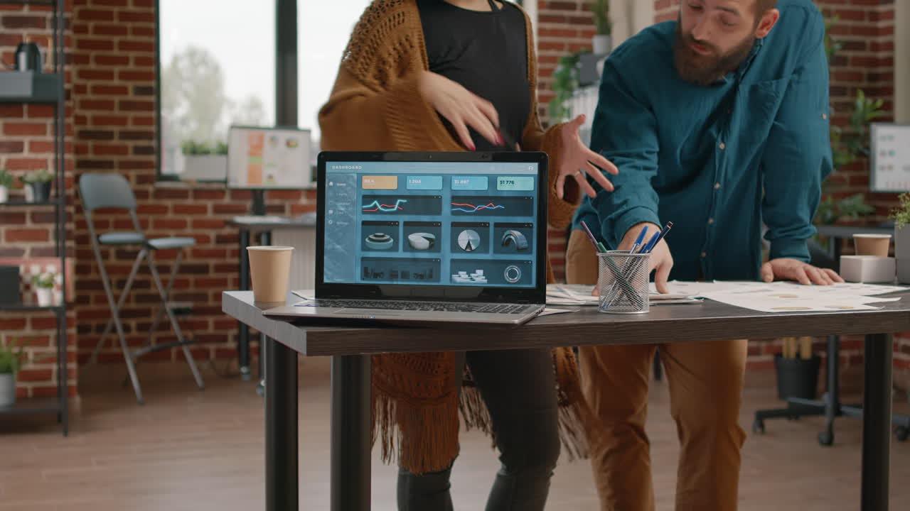 Business team analyzing data on a laptop in the office
