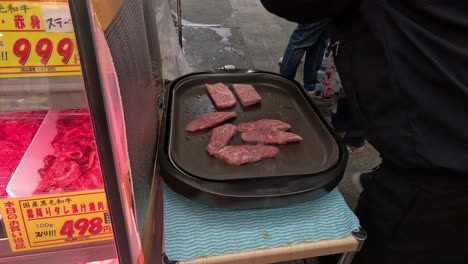 various cuts of meat on display for sale.