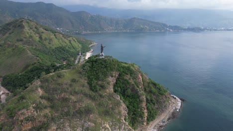 a scenic coastline with lush green hills and calm blue waters near timor leste , aerial view