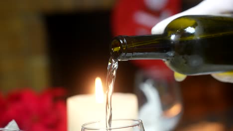 Pouring-white-wine-at-home-in-a-Christmas-celebration-dinner