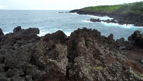 Varadouro-natural-swimming-pools-with-volcanic-rocks,-aerial-opening