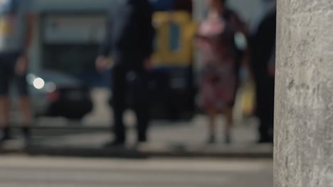 people walk along the pedestrian crossing cars pass by 1