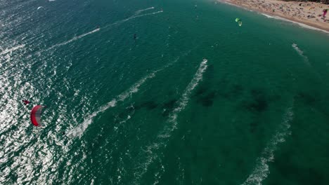 circle pan aerial view of kitesurfers practicing and having fun and landscape at tarifa beach, cadiz, spain
