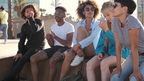 Content-young-friends-chilling-on-city-seafront