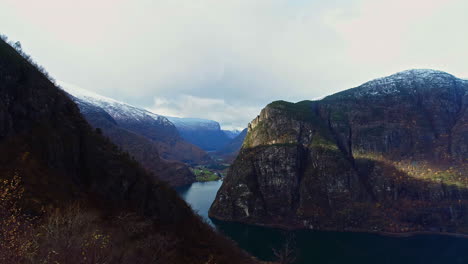 Drone-Fly-Over-The-Road-Fence-To-The-Scenic-Lake-Between-The-Mountains