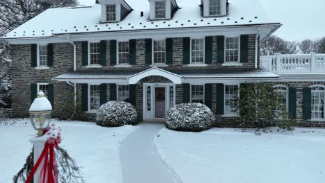 Aerial-close-up-of-an-old-stone-home-with-green-shutters