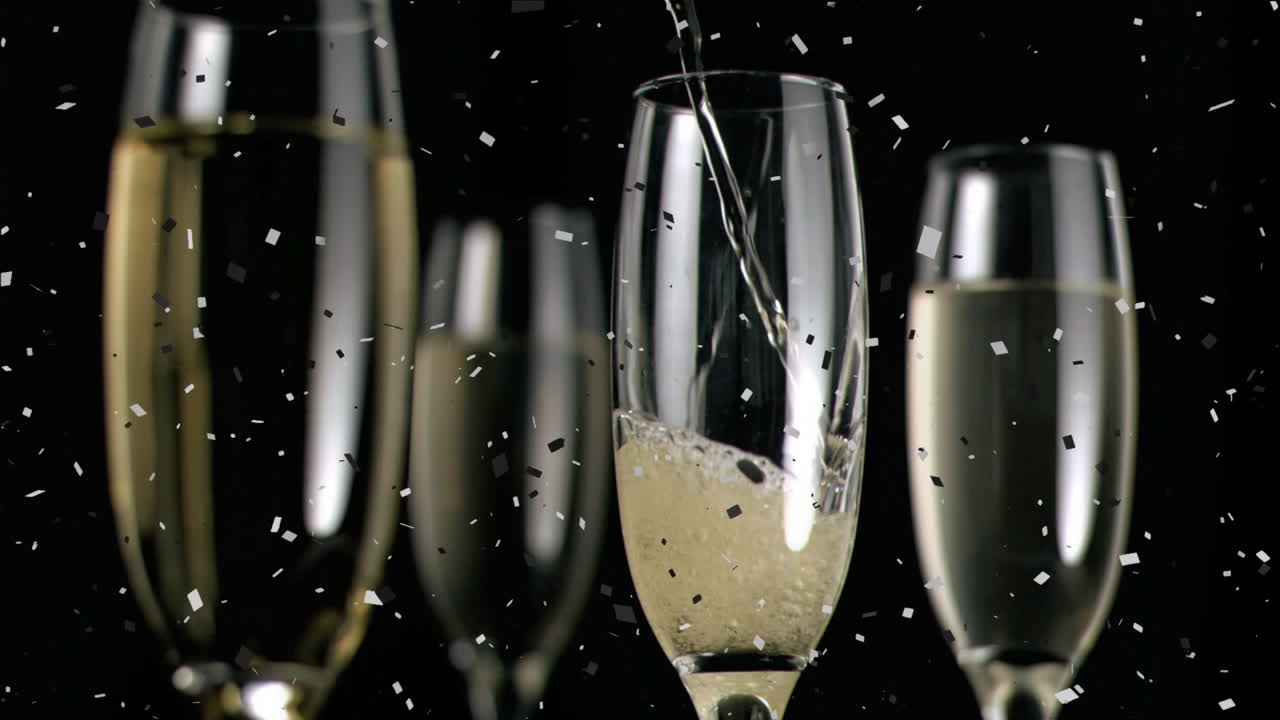Animazione di coriandoli su bicchieri di champagne su sfondo nero