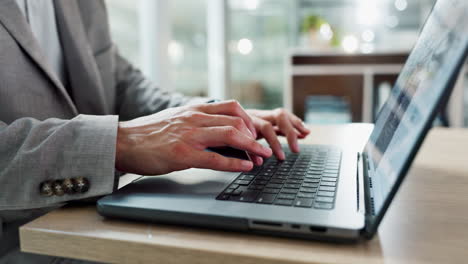 Hands-typing,-laptop-and-keyboard-at-desk