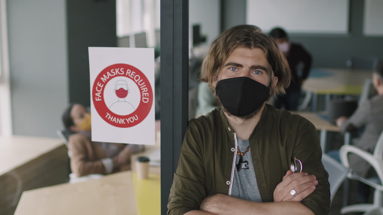 Office worker with face mask in social distancing environment