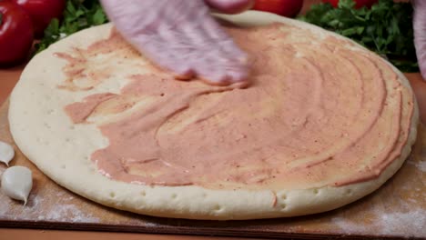 preparing pizza with tomato sauce