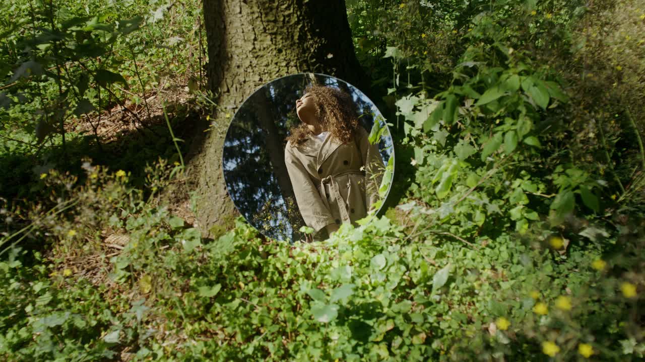 Woman Reflected in Mirror in Forest