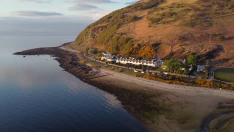 Aerial-view-of-the-Scottish-town-of-Catacol-on-the-Isle-of-Arran-at-sunset,-Scotland