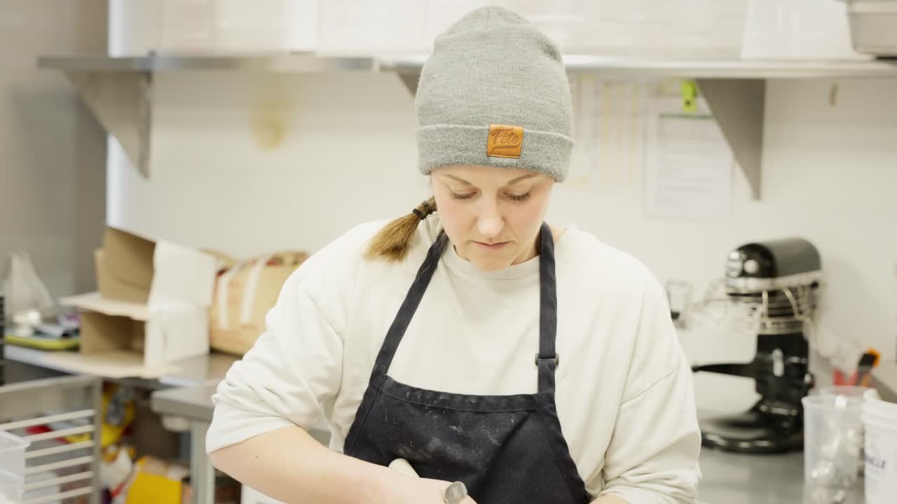 Baker Kneading Dough in a Bakery Kitchen