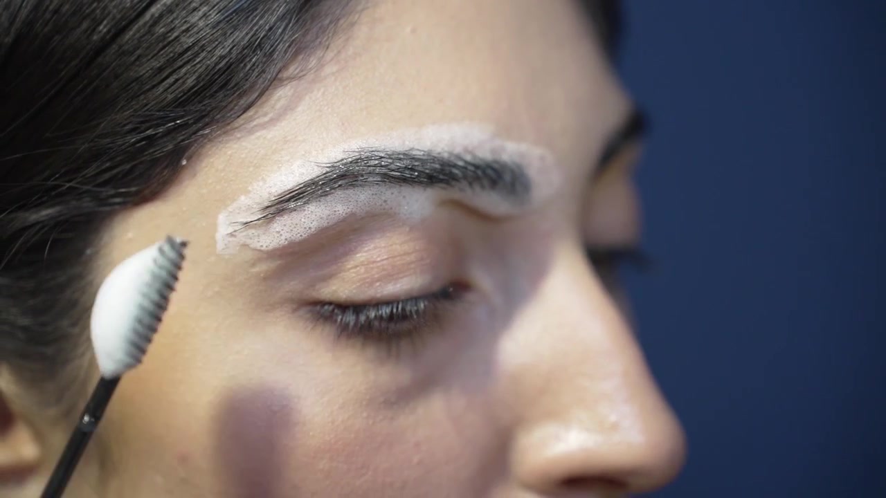 Pigment Mask Removal from Eyebrows , Young Woman Closeup at Beauty Salon