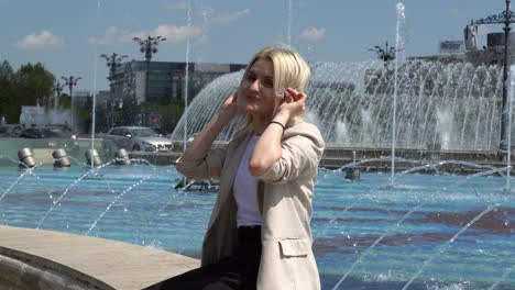 Blonde-Young-Woman-Enjoying-the-Vibrant-Atmosphere-of-Piata-Unirii-Square-in-Bucharest,-Romania