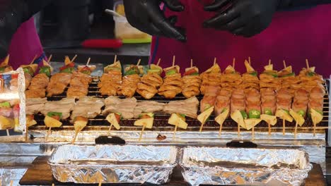 street food vendors preparing grilled skewers