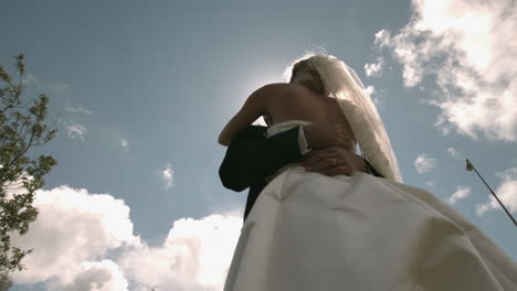 beautiful newlywed couple dancing in sunlight