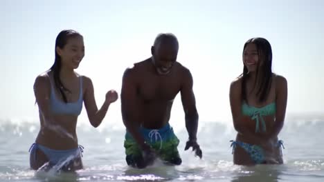 a joyful day at the beach: friends enjoying each other's company while playing in the waves and embracing the refreshing ocean water on a sunny day