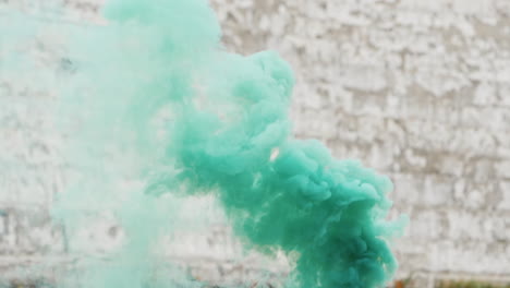 Green-Smoke-On-The-Background-Of-An-Old-Brick-Wall-In-White