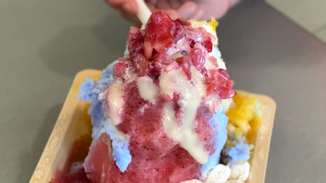 people eating delicious hawaiian shaved ice; close up