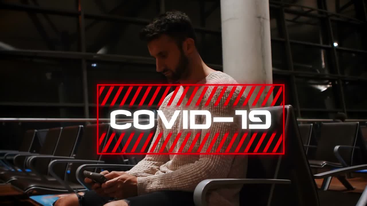 Animation of the word Covid-19 written in red frame over man using a smartphone in the background.