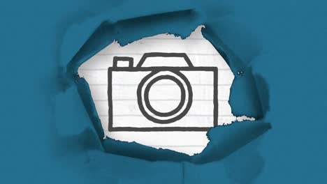 Animation-of-black-outlined-camera-icon-drawn-with-a-marker-with-ripped-blue-paper-in-the-foreground