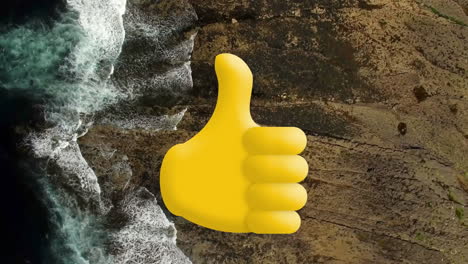 digital composition of thumbs up icon against aerial view of the sea waves