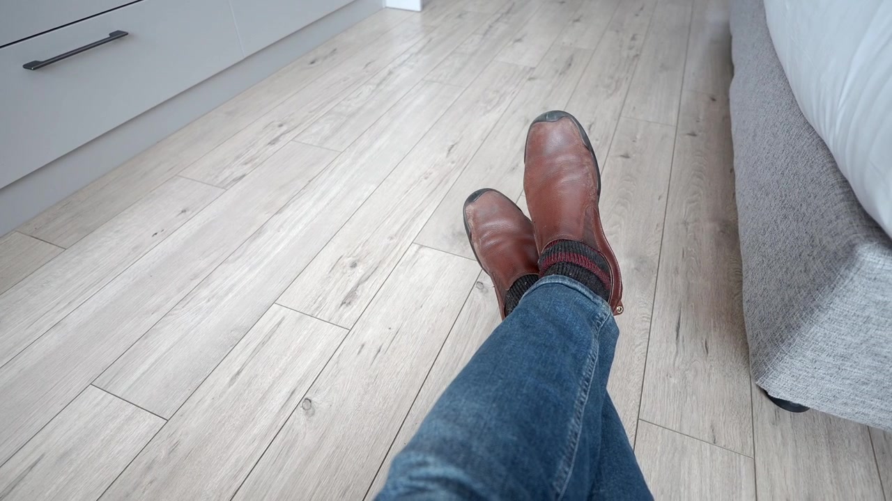 Person Relaxing at Home With Feet Crossed