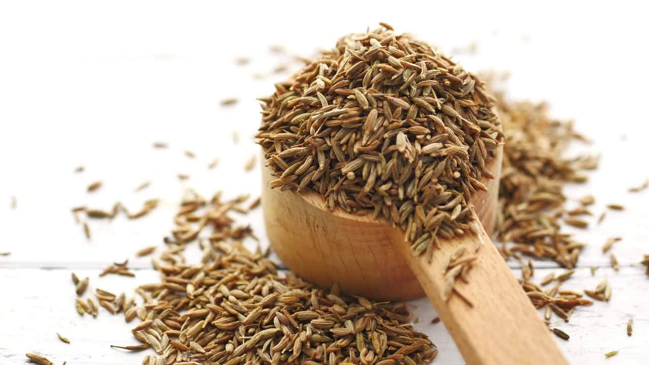 Cumin Seeds in a Wooden Spoon