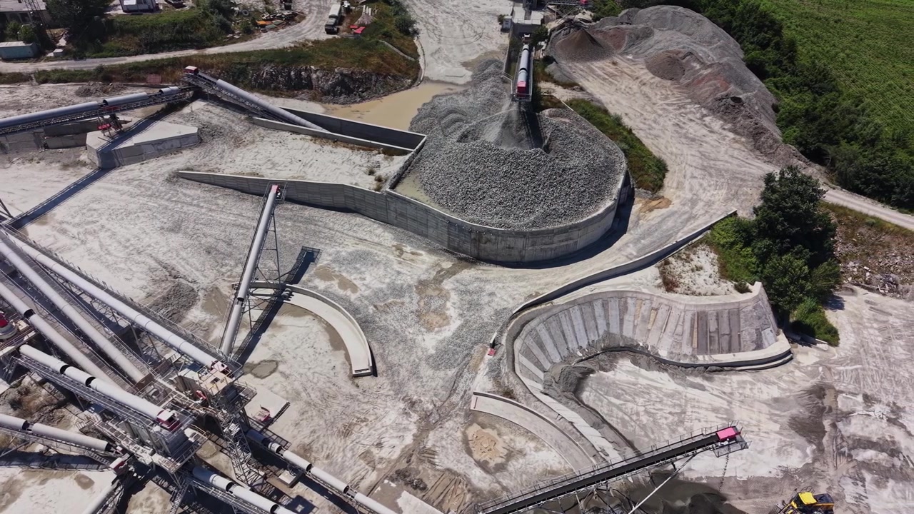 Construction site with machinery and gravel processing in daytime