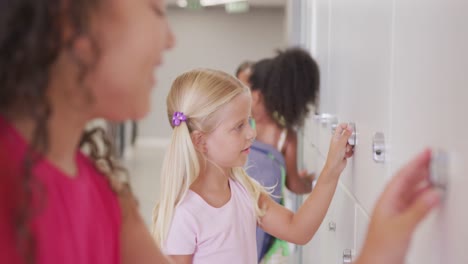 video of happy diverse girls opening school lockers