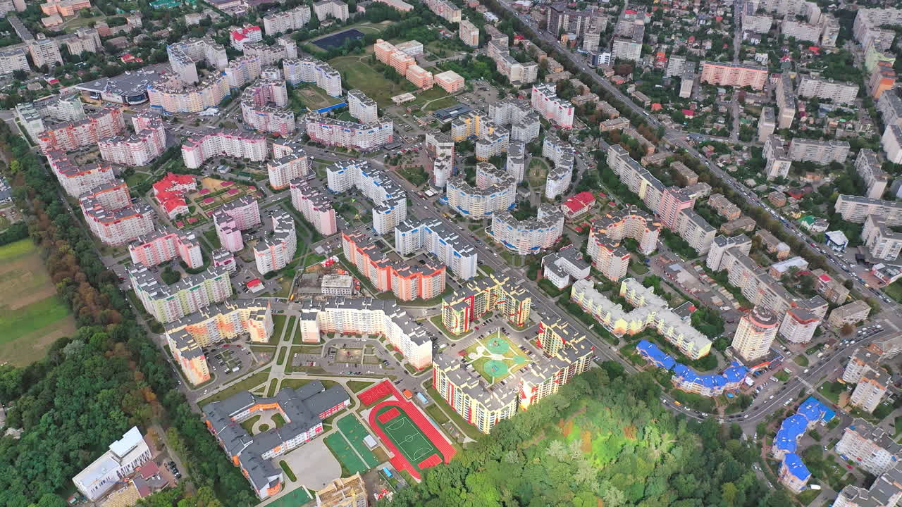 Urban landscape with green plantings. High-rise housing apartments of a new residential complex in modern city district. Aerial view.