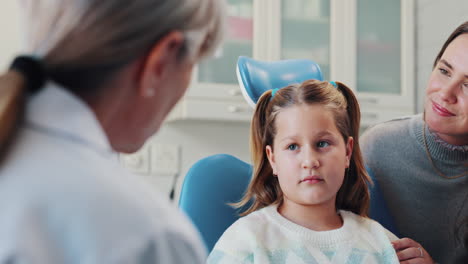 child patient with her mother at the dentist
