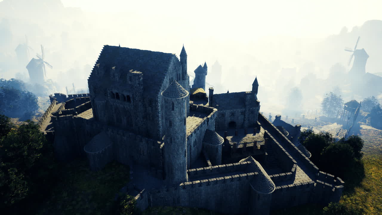 Imposing medieval castle surrounded by misty hills and windmills